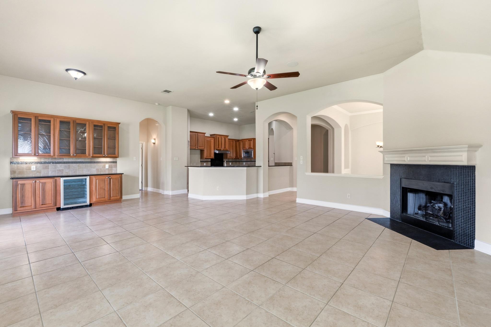 A spacious common area with a wet bar, a modern f