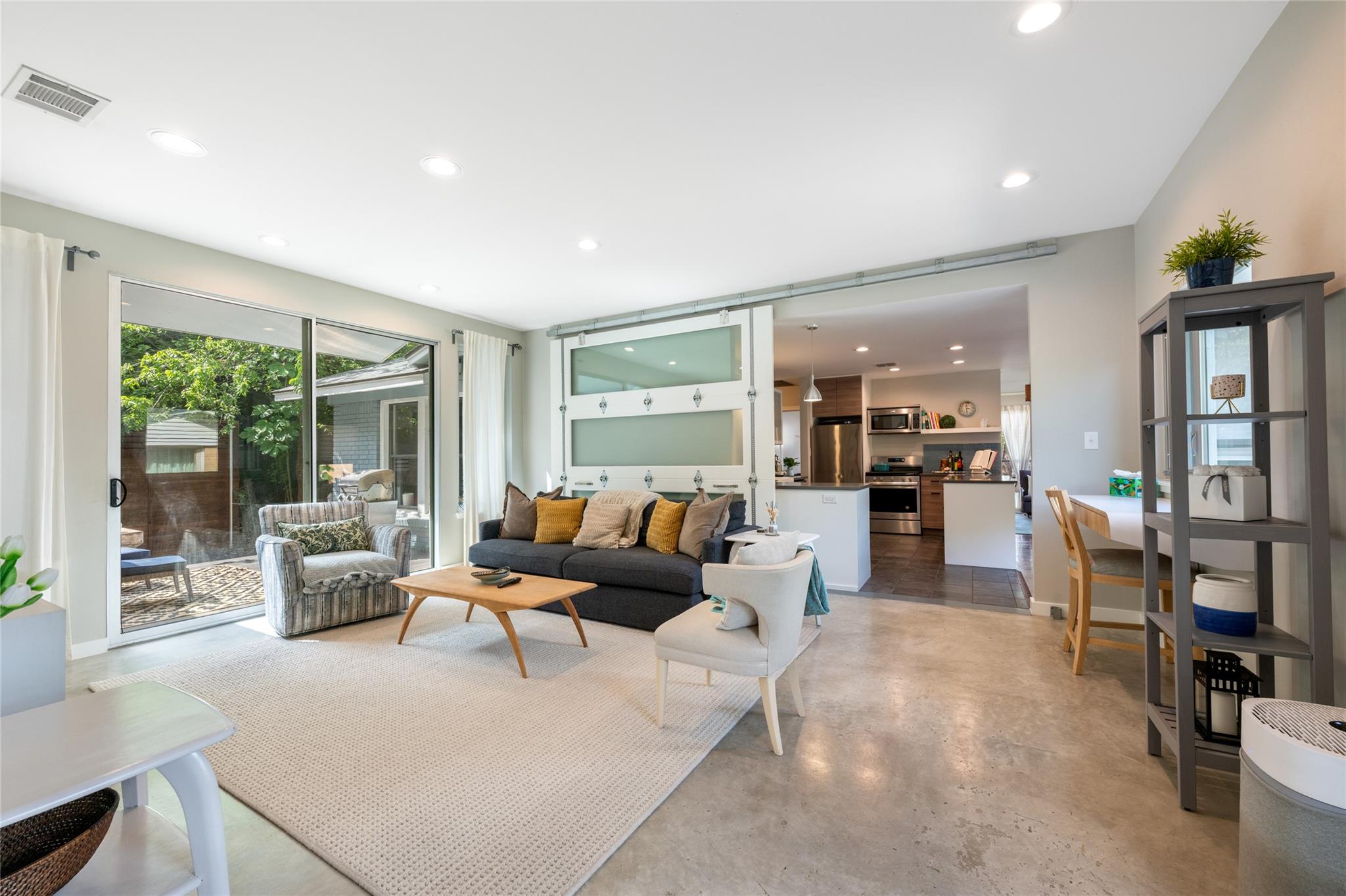 An open-concept living area boasts polished concr