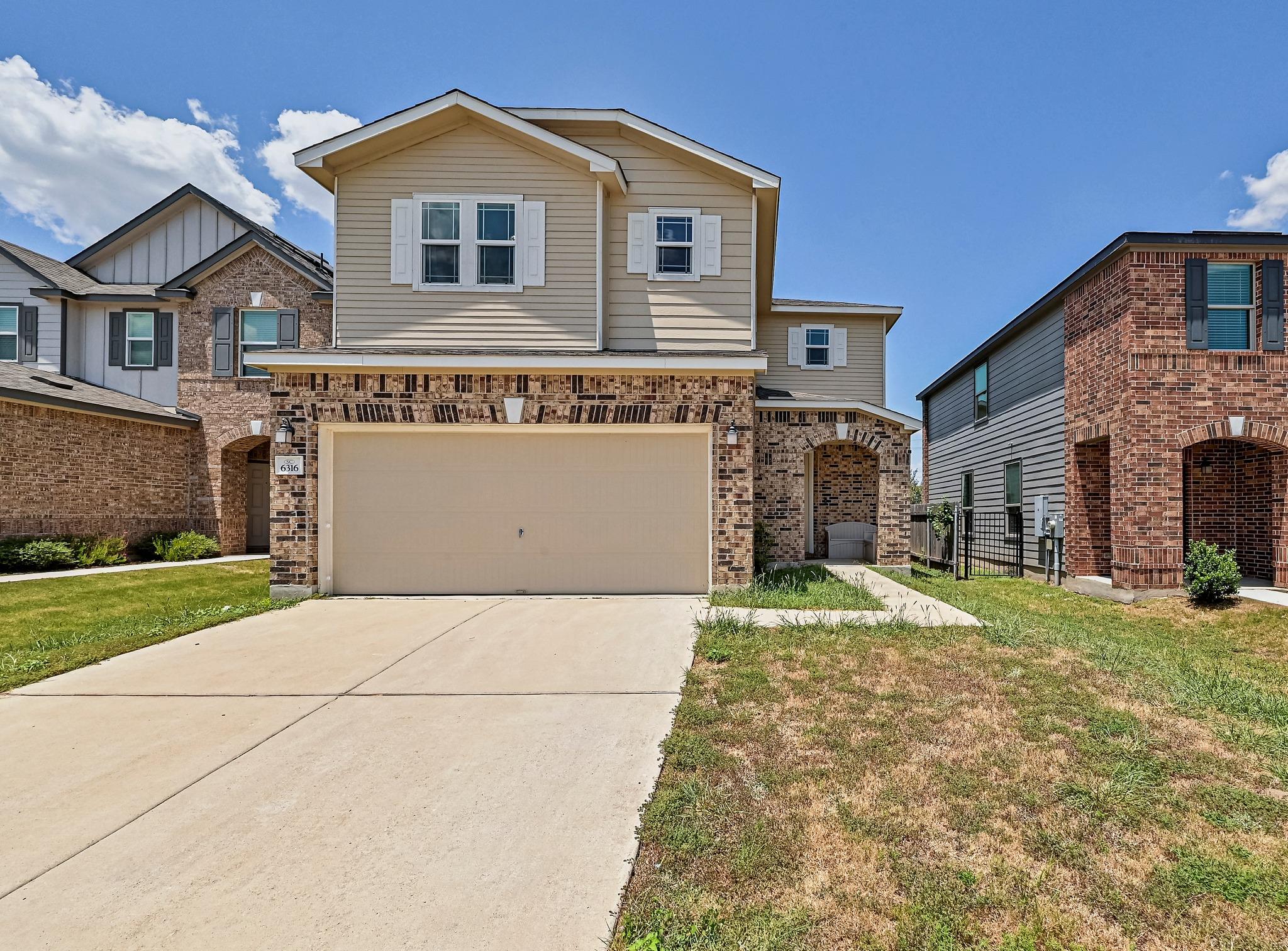 A classic brick and siding two-story home, with a