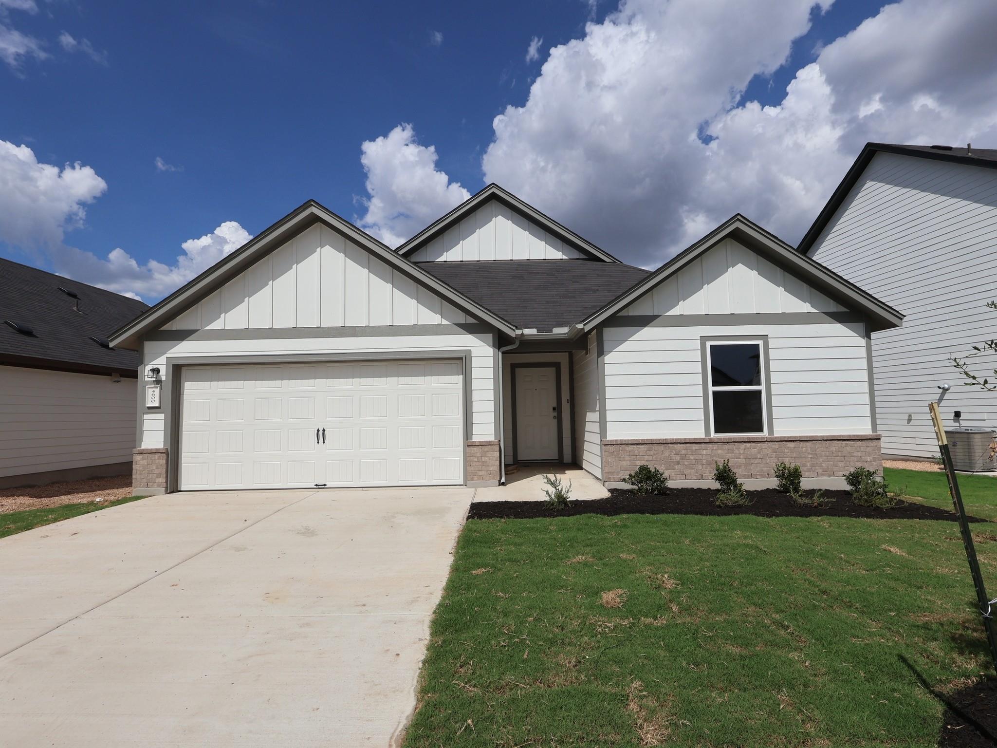 Crisp white siding paired with stone accents defi