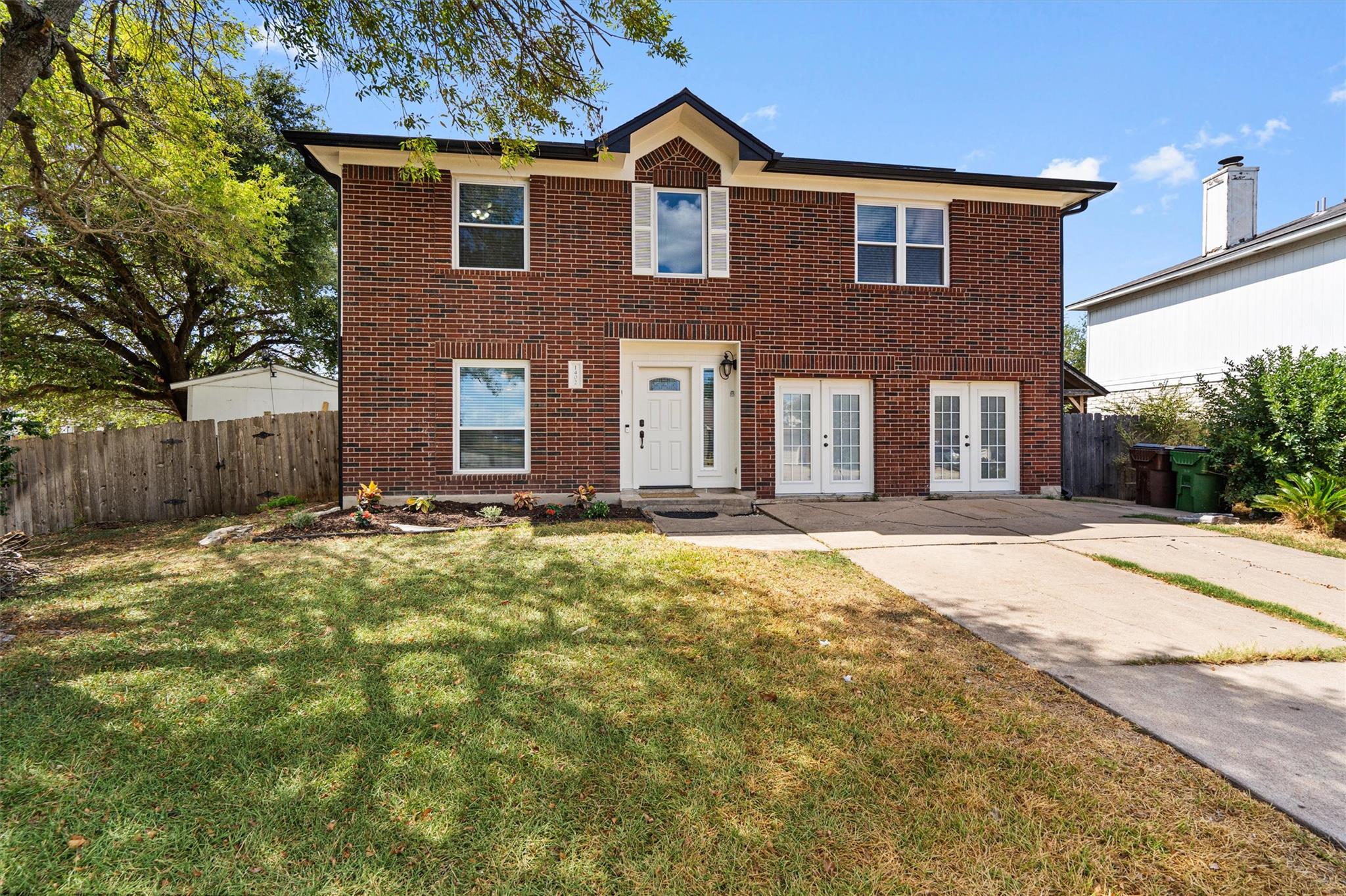 A classic two-story brick exterior features a spa