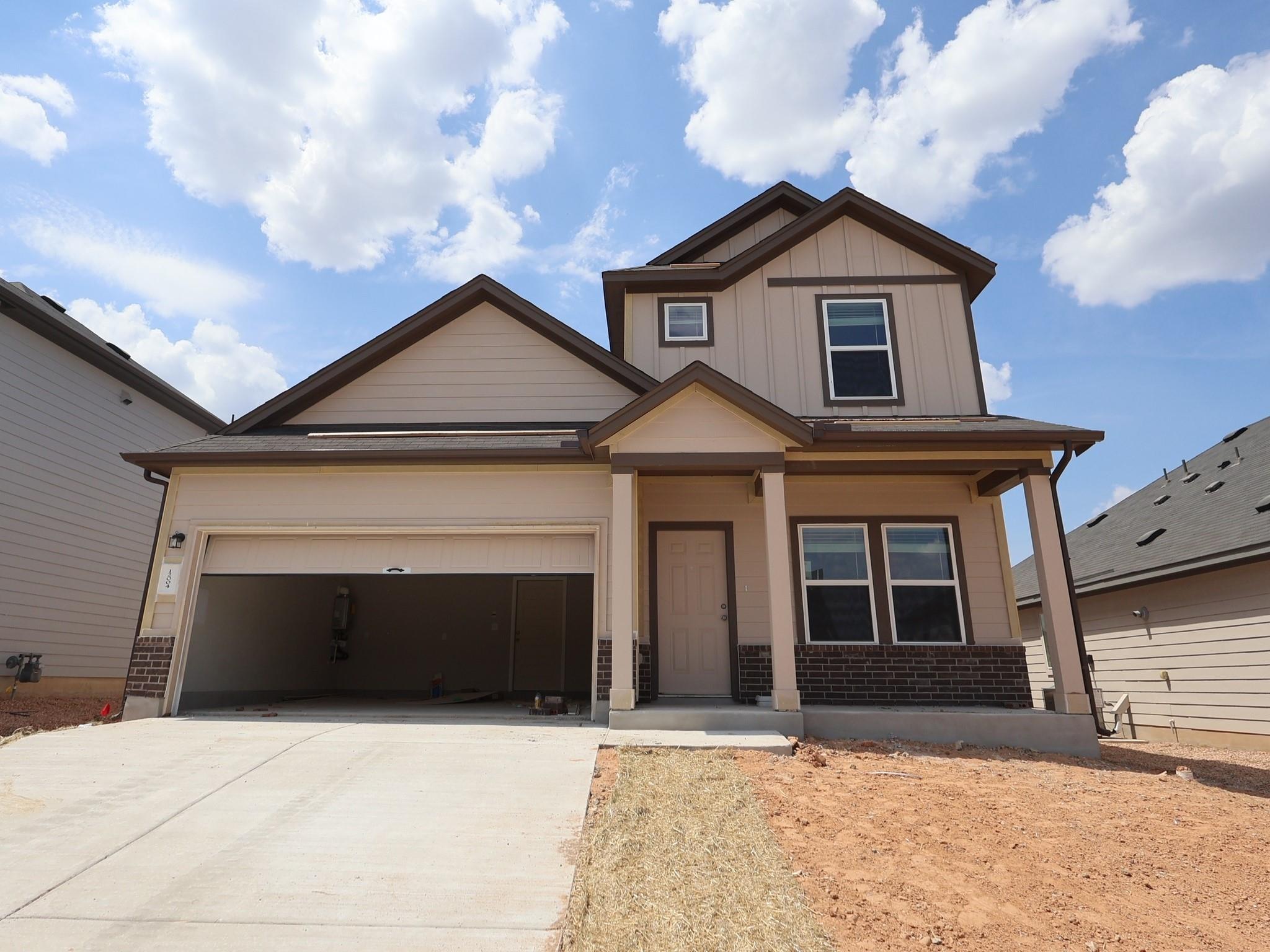 Multi-textured siding and brick accents define th