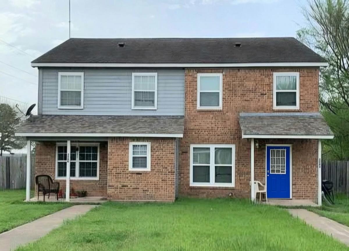 A classic brick and siding duplex presents a bala