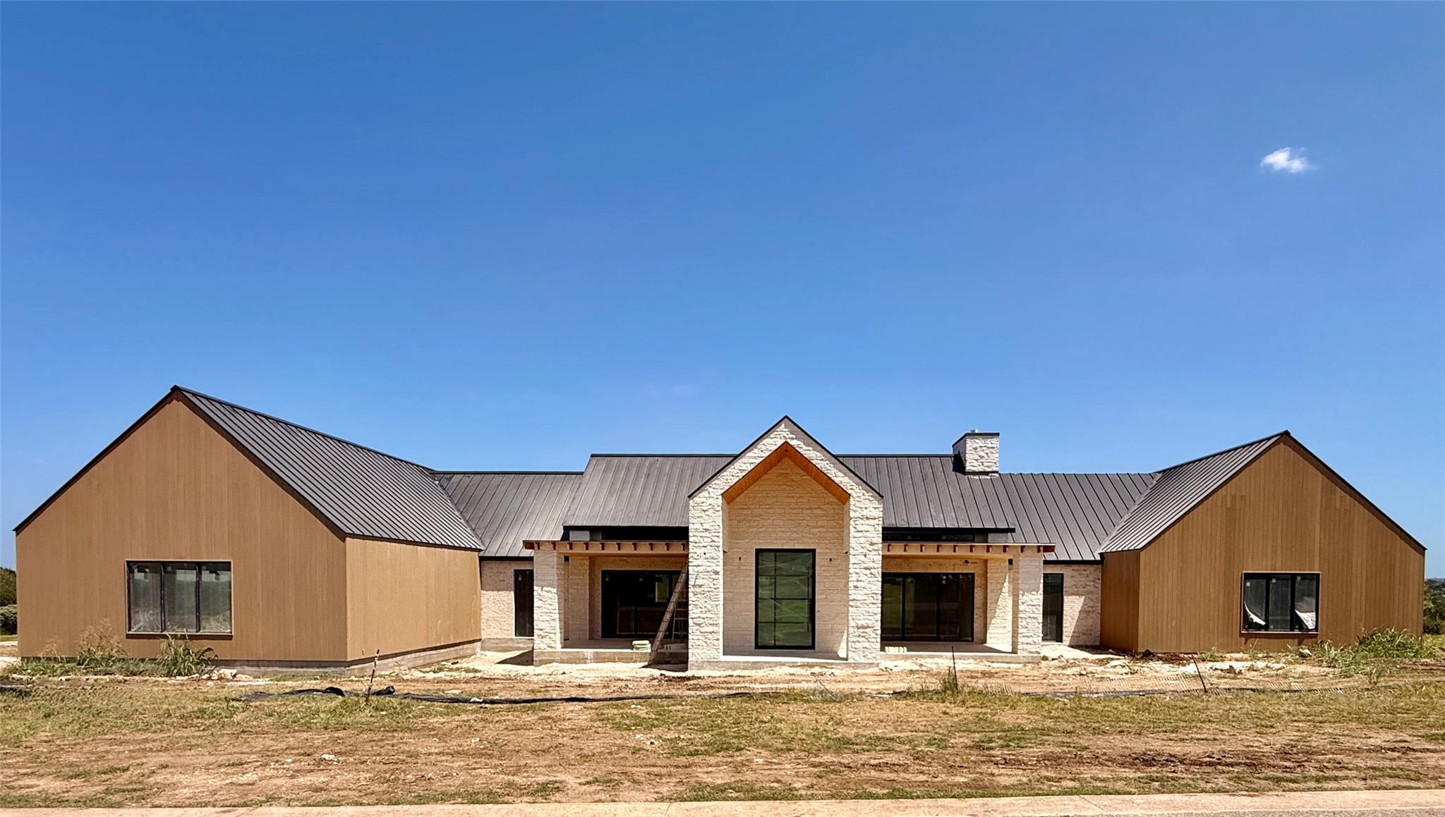 A newly constructed modern farmhouse boasts a str