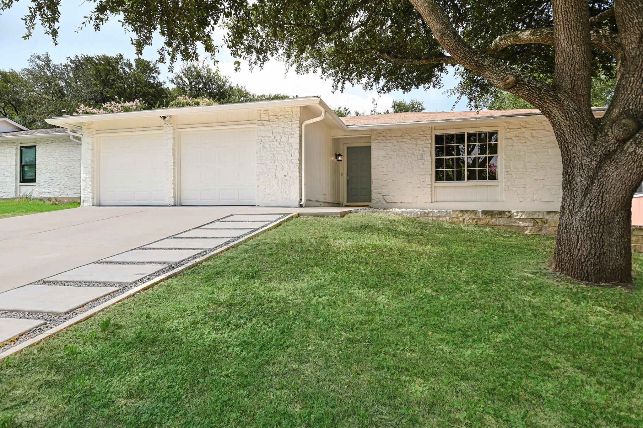 White stone facade and two-car garage define this