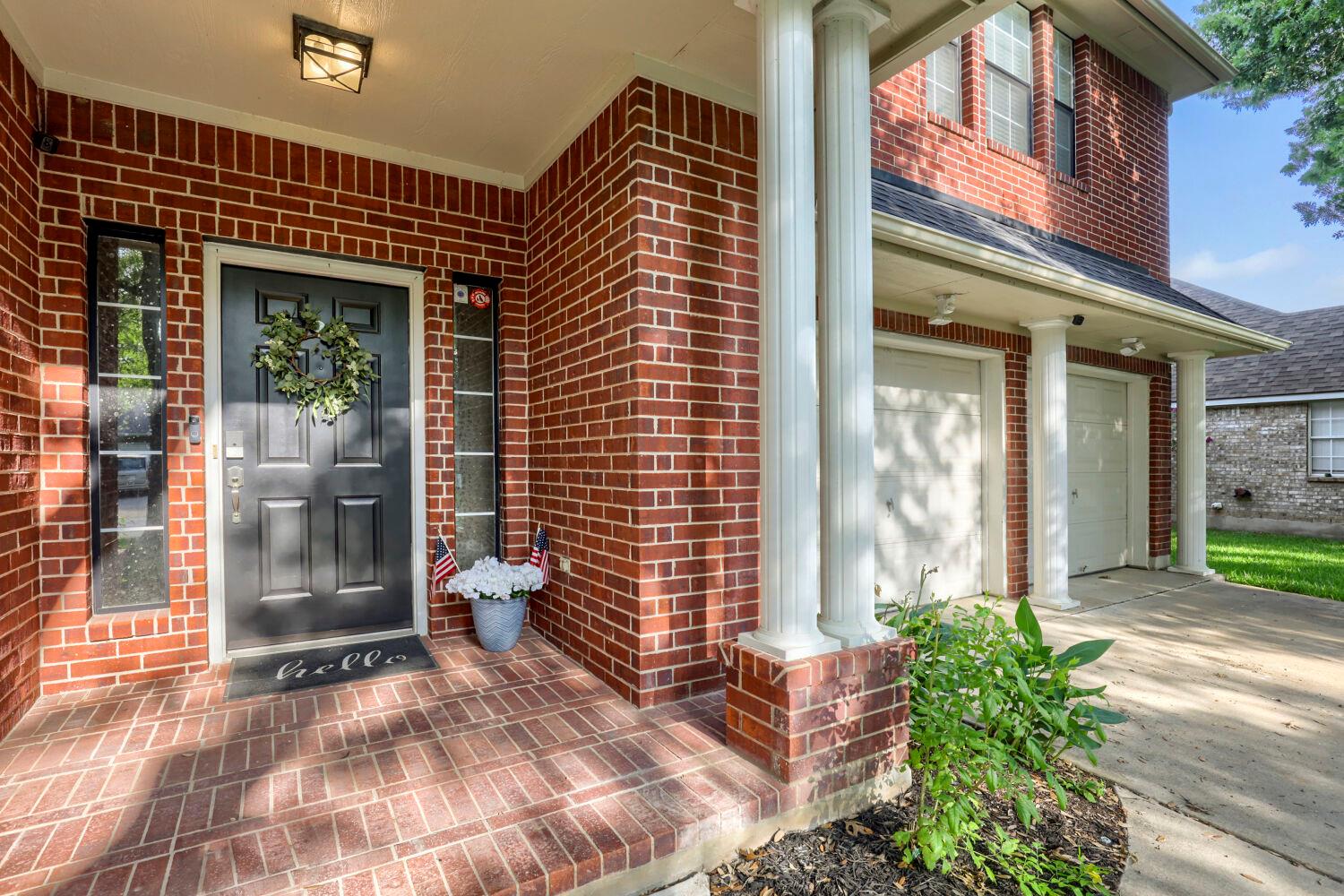 A classic brick exterior welcomes with stately co