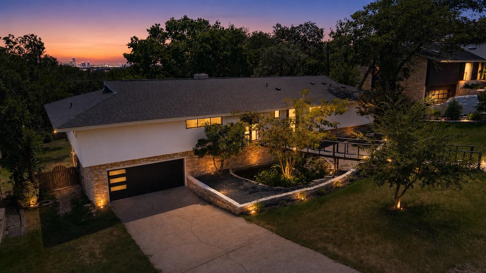 Dusk falls over this multi-level home featuring a