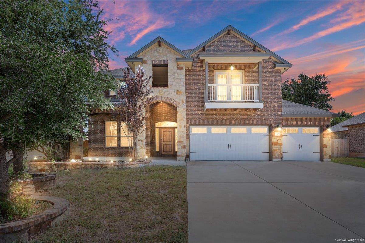 A striking brick and stone facade welcomes with a
