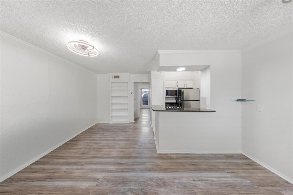 A well-lit living area features built-in shelving
