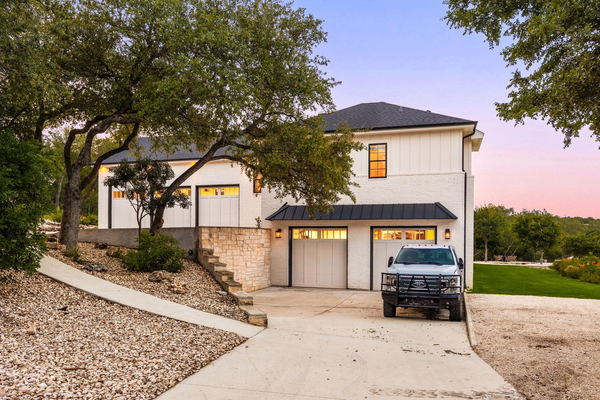 A striking white facade with multiple garage door