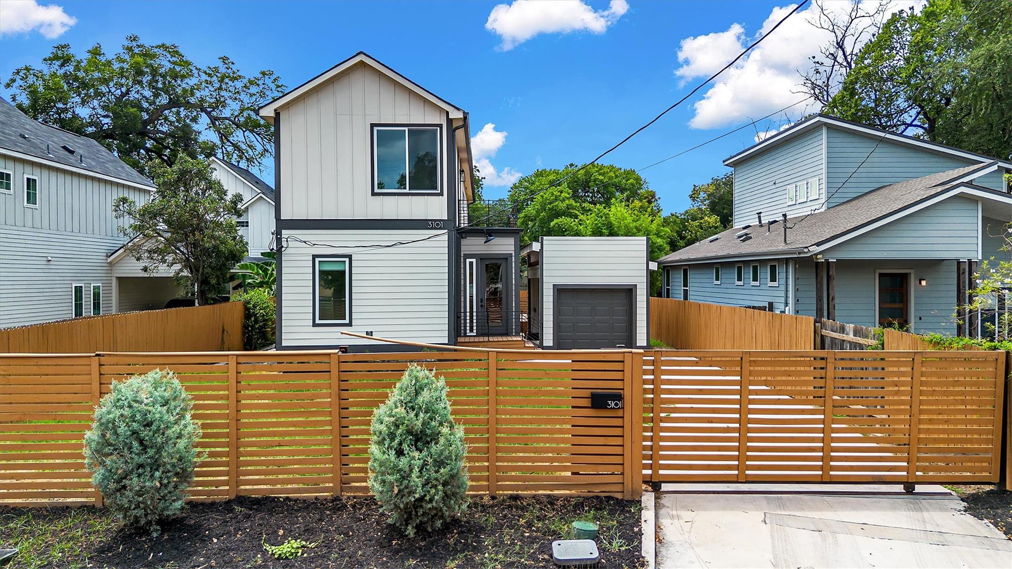 Modern home exterior with crisp siding and a natu