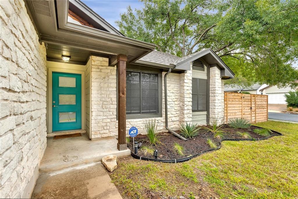 A welcoming stone facade with a vibrant front doo