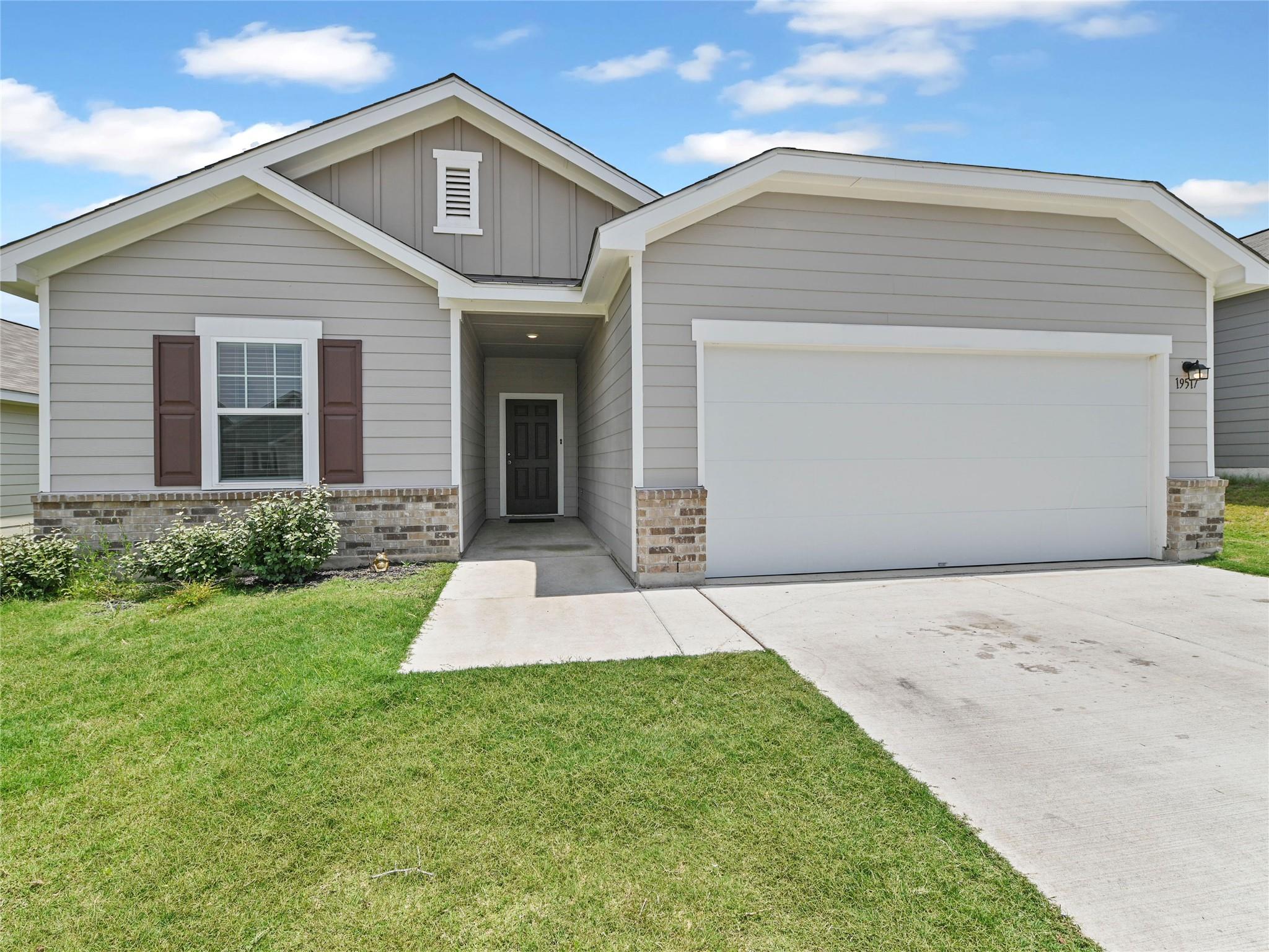 A welcoming facade with a garage, inviting walkwa