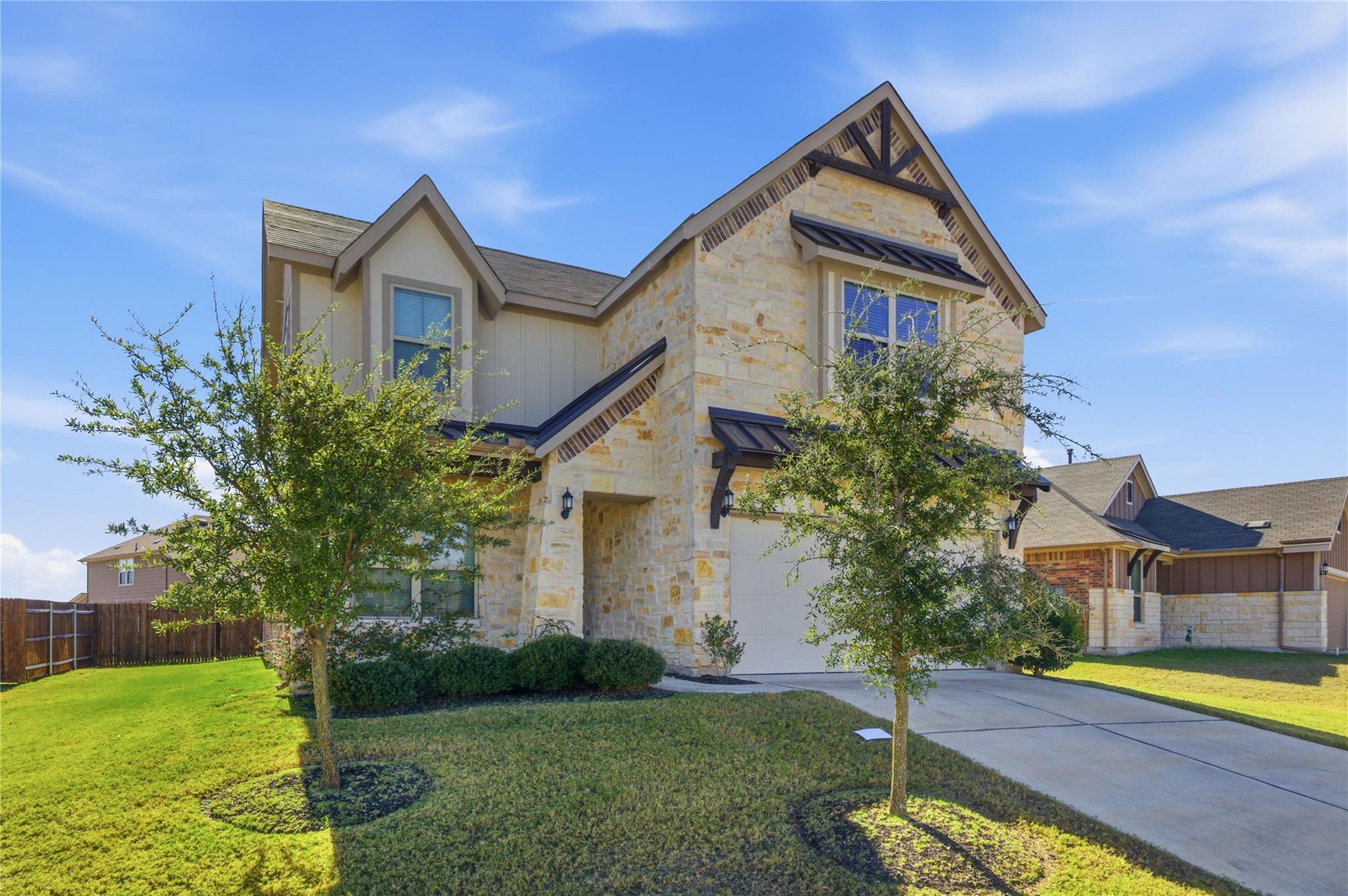 A classic stone and siding home with a welcoming 