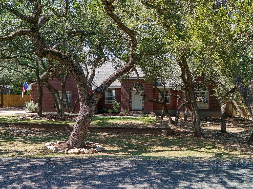 Mature trees shade this charming brick residence,