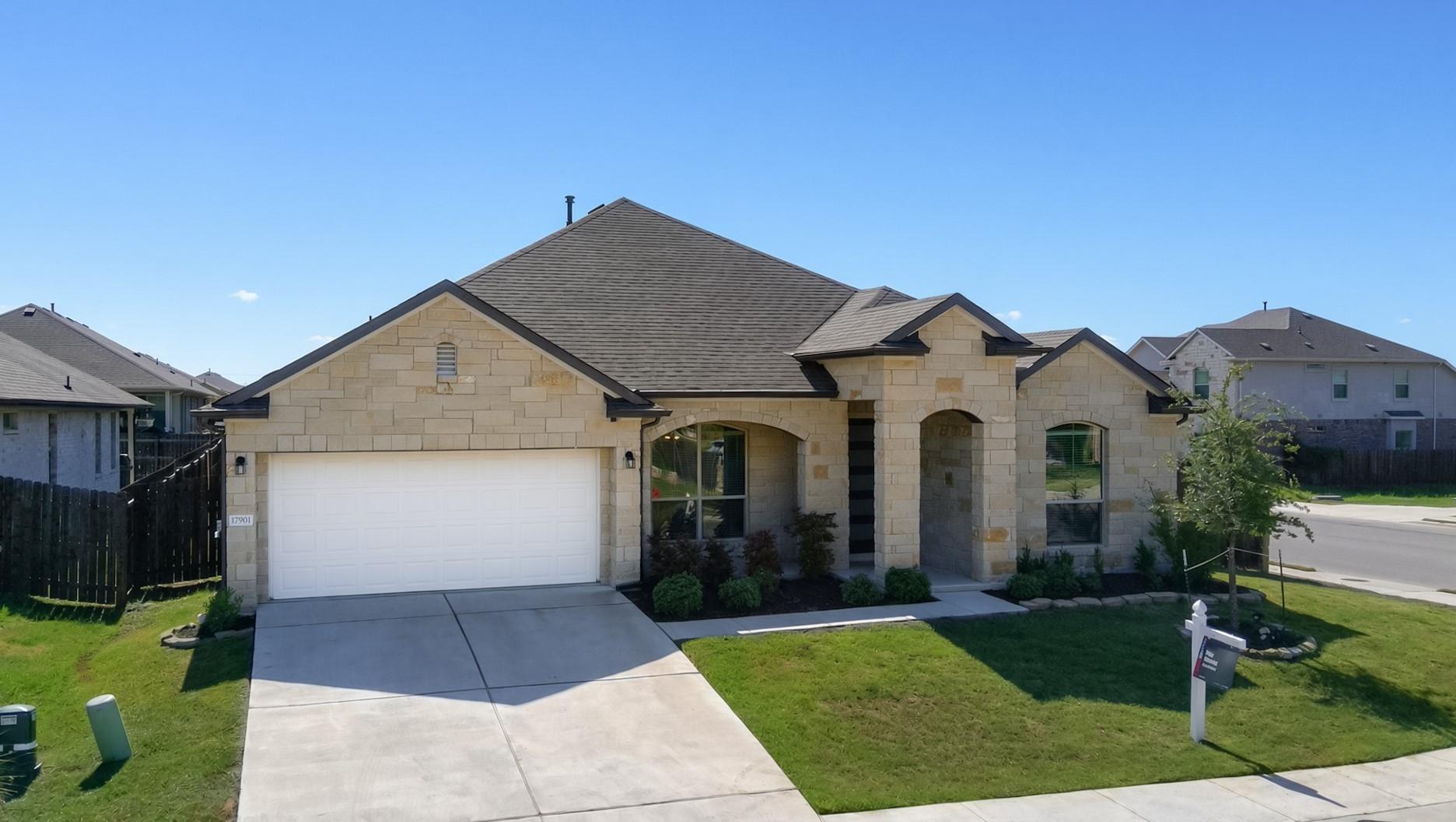 A classic stone exterior and neat driveway define