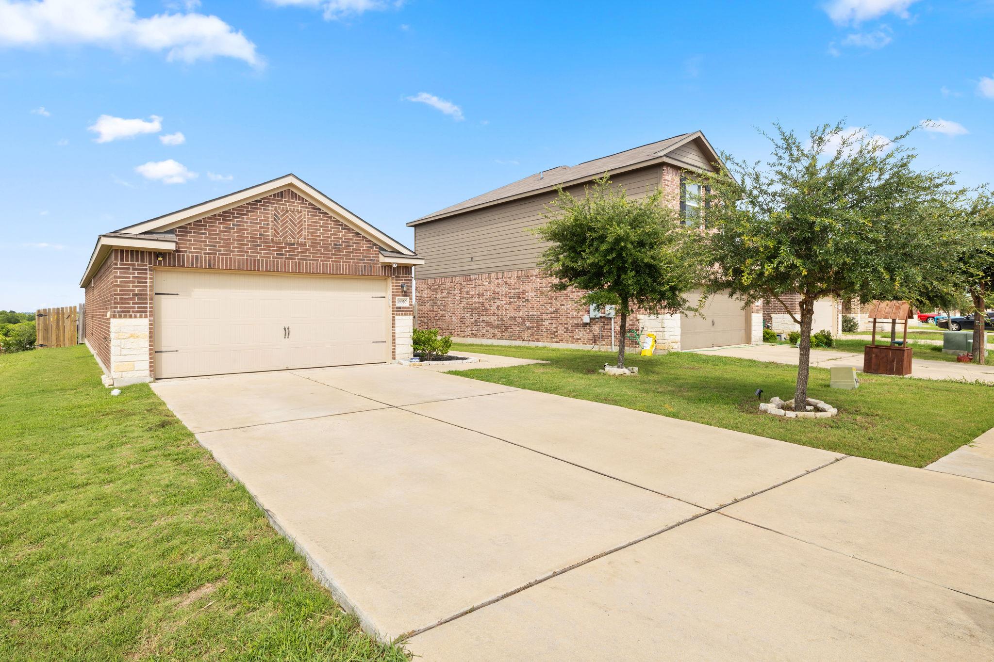 A well-maintained concrete driveway leads to a ch