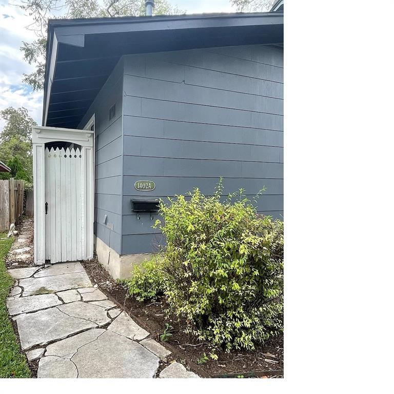 A quaint pathway leads to a charming residence, e