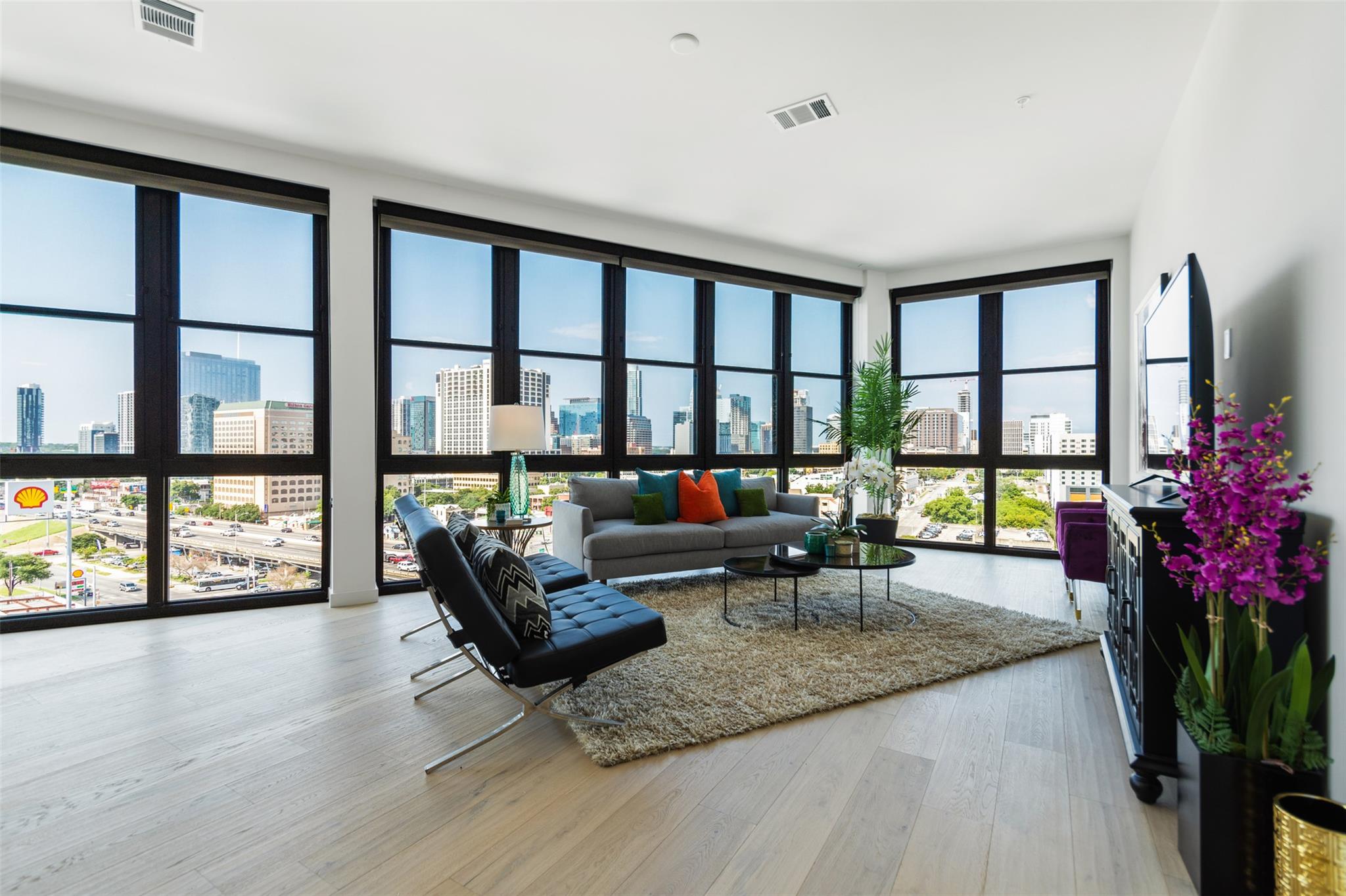 Living area with floor to ceiling windows and lig