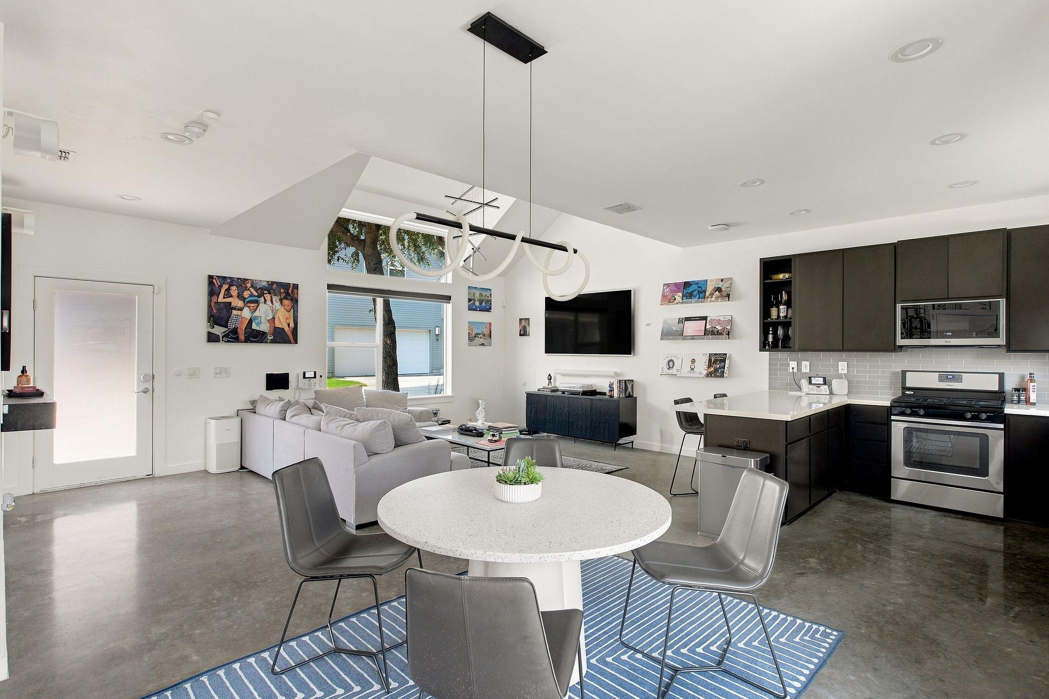 Sleek polished concrete floors ground the airy, o