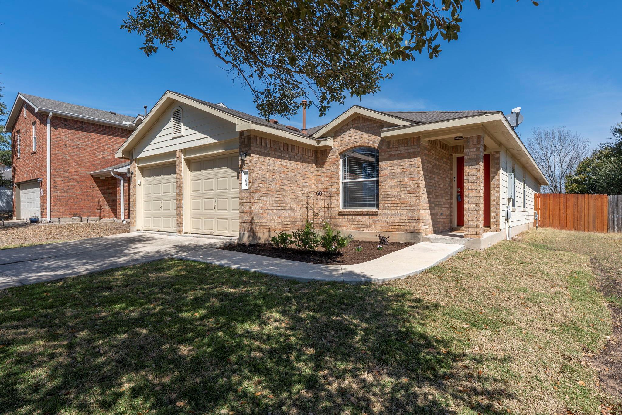 A well-kept front yard offers inviting curb appea