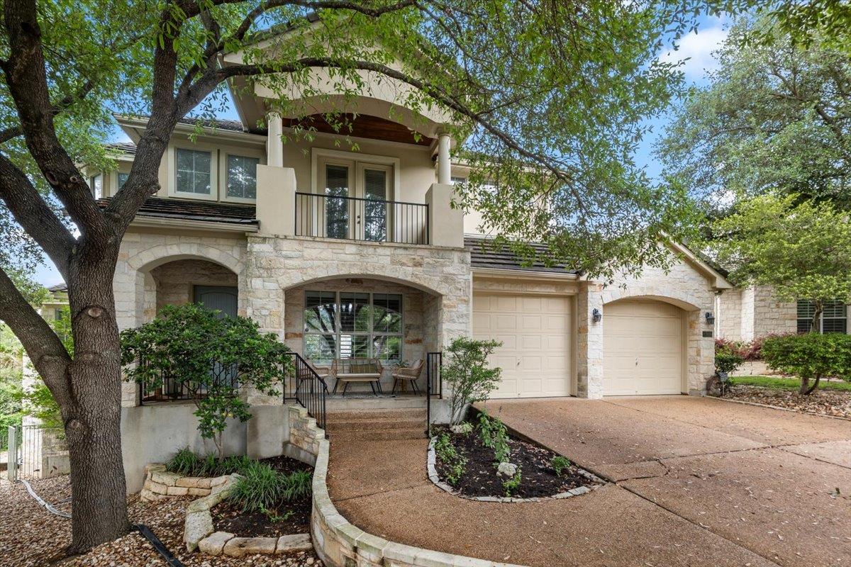 Stone veneer exterior featuring arched entryways 