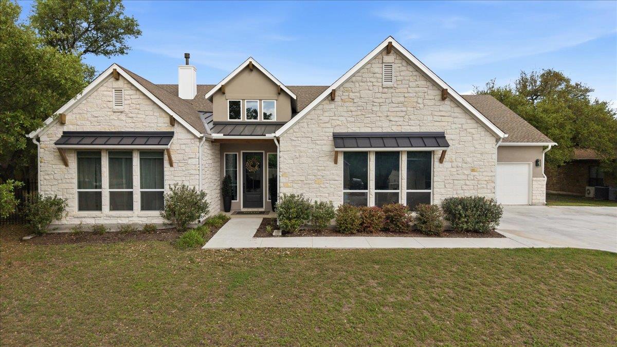 A graceful stone and stucco exterior welcomes wit