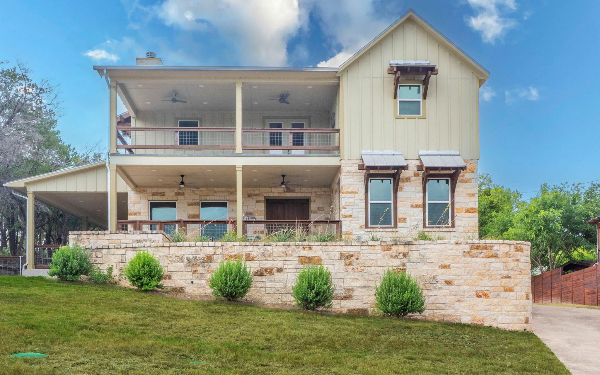 A charming stone and siding facade offers tiered 