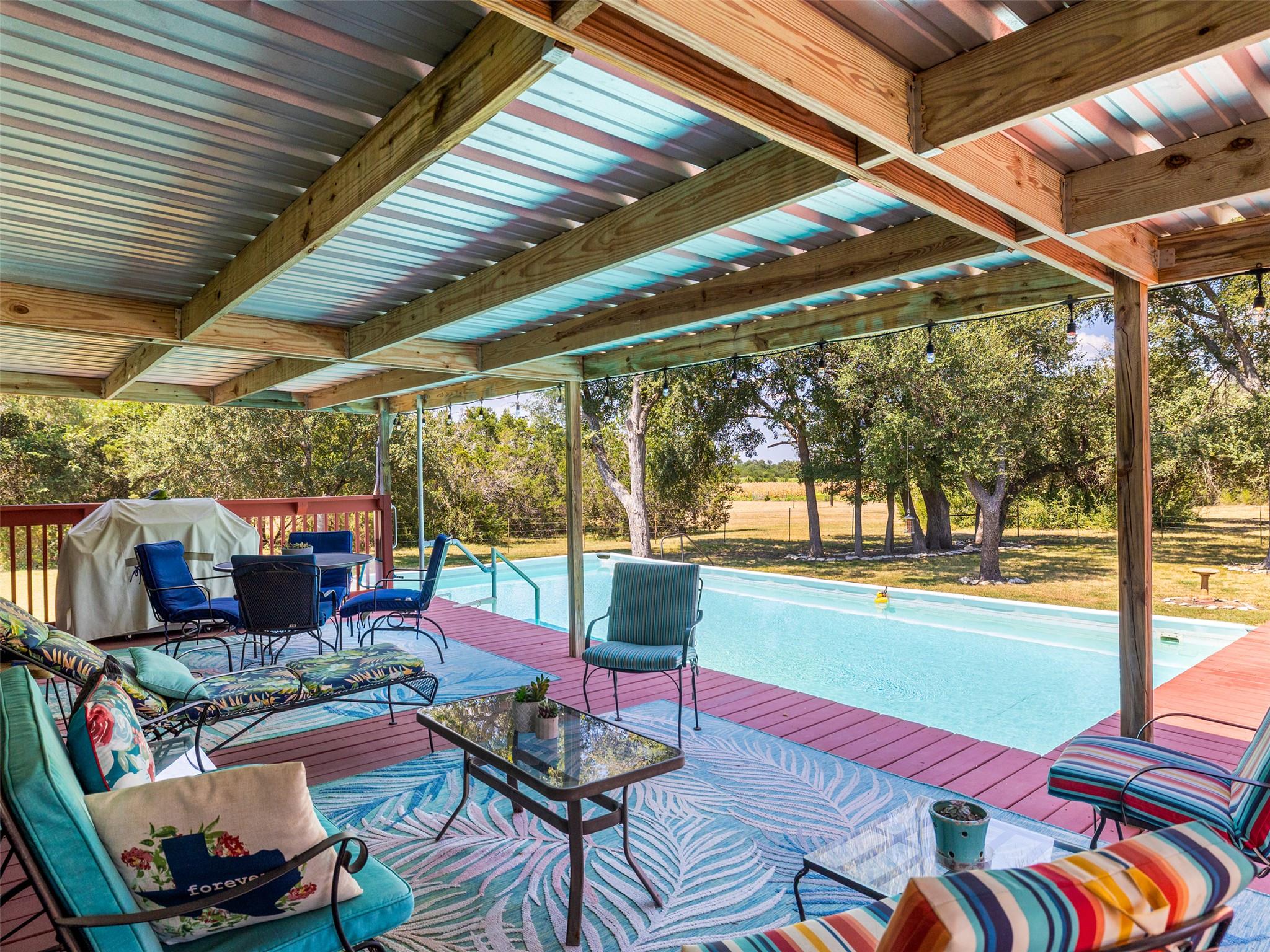 An inviting covered patio with a vivid blue and r