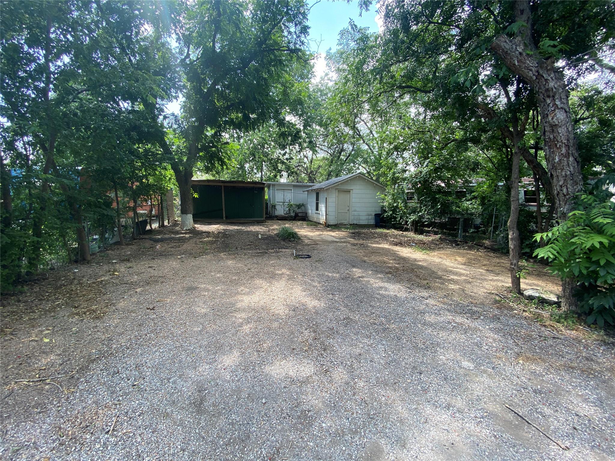 A spacious gravel lot provides ample parking, sur