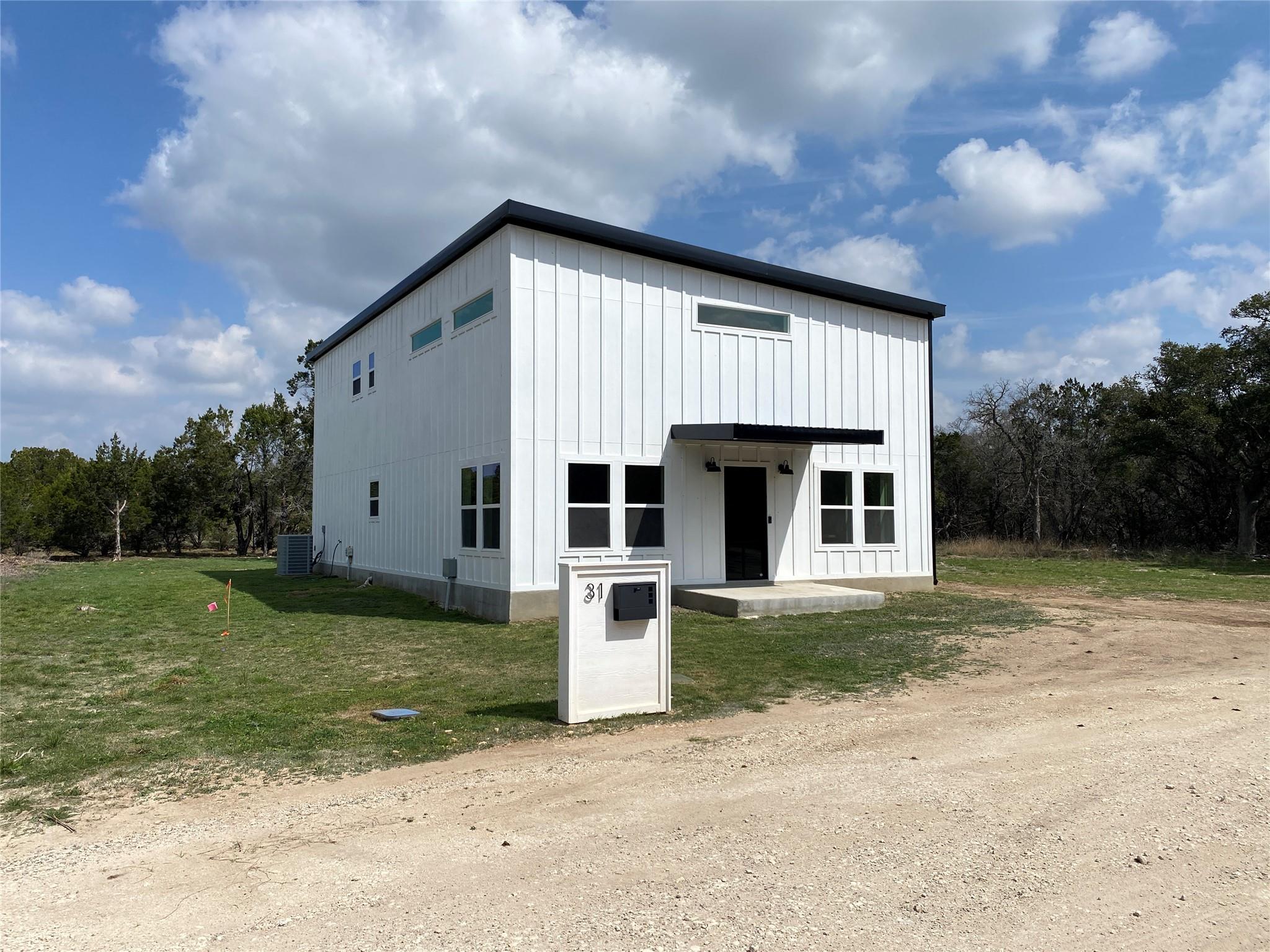 A striking modern farmhouse design features a cri