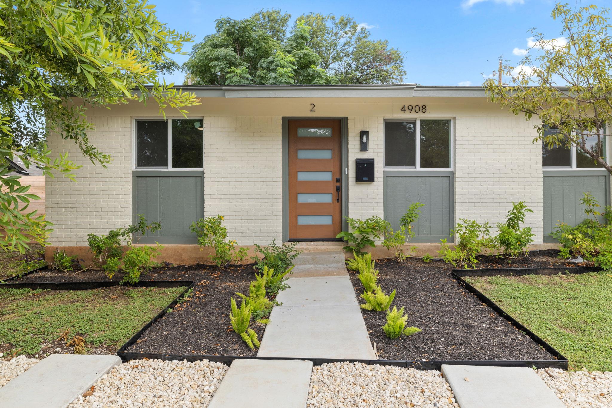 A well-maintained facade features modern landscap