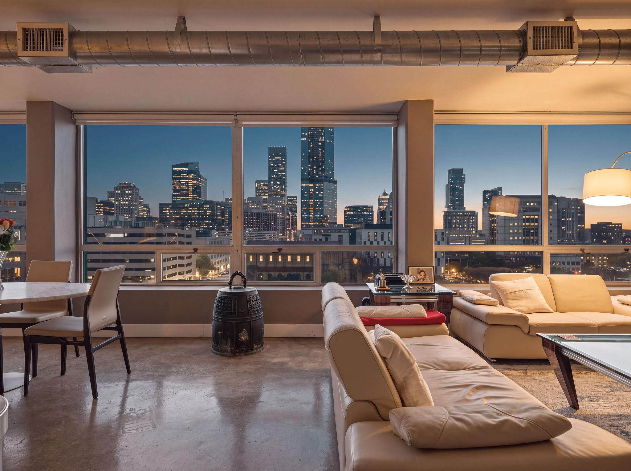 Floor-to-ceiling windows frame a mesmerizing city