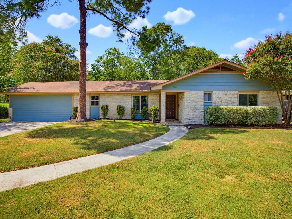 A classic ranch home presents with a tidy lawn an