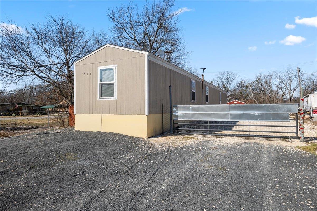Securely fenced mobile home on a clear day, offer