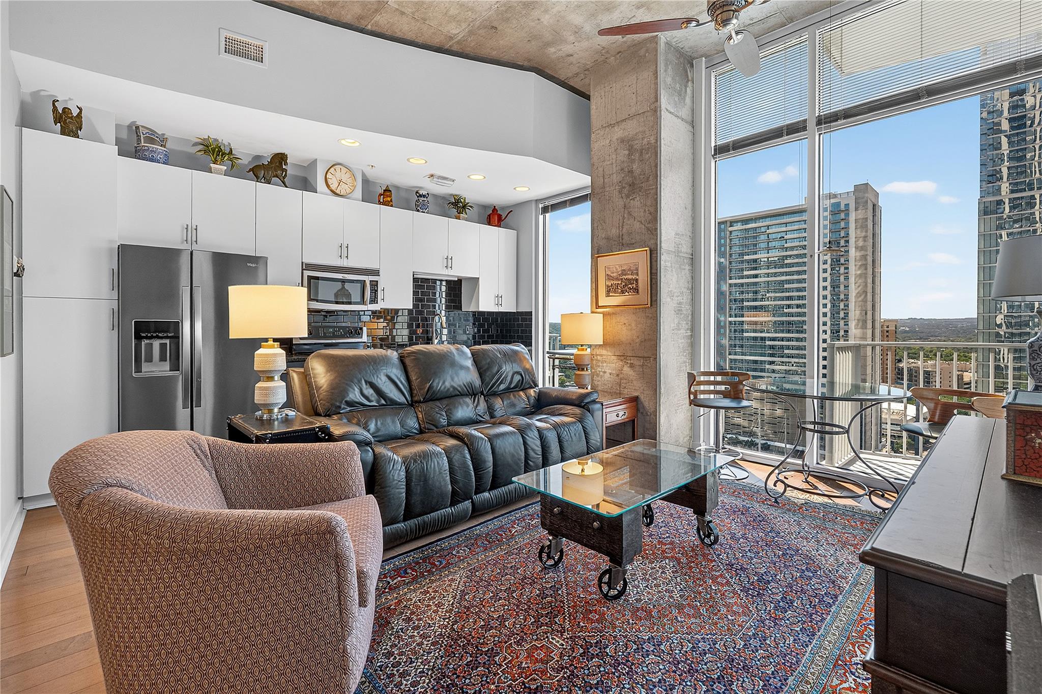 Floor-to-ceiling windows frame sweeping city view