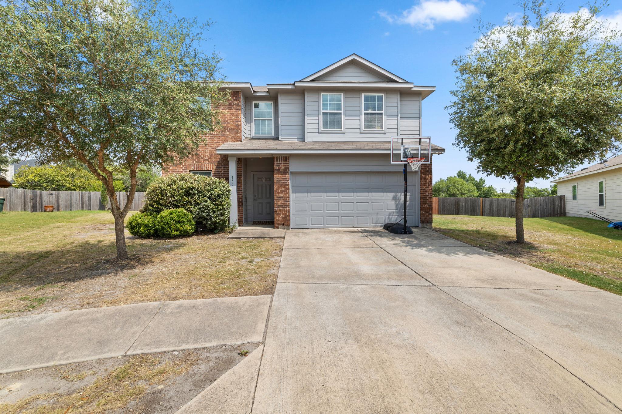 A classic brick and siding two-story home, presen