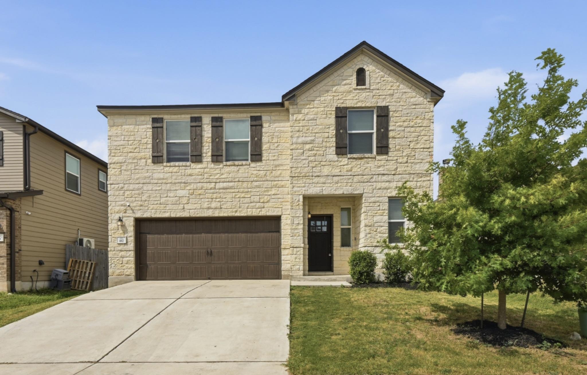 A charming two-story home with a stone facade and