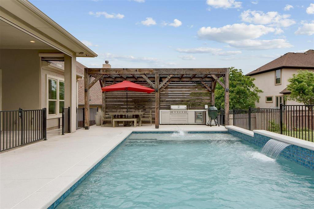 An inviting backyard oasis offers a sparkling poo