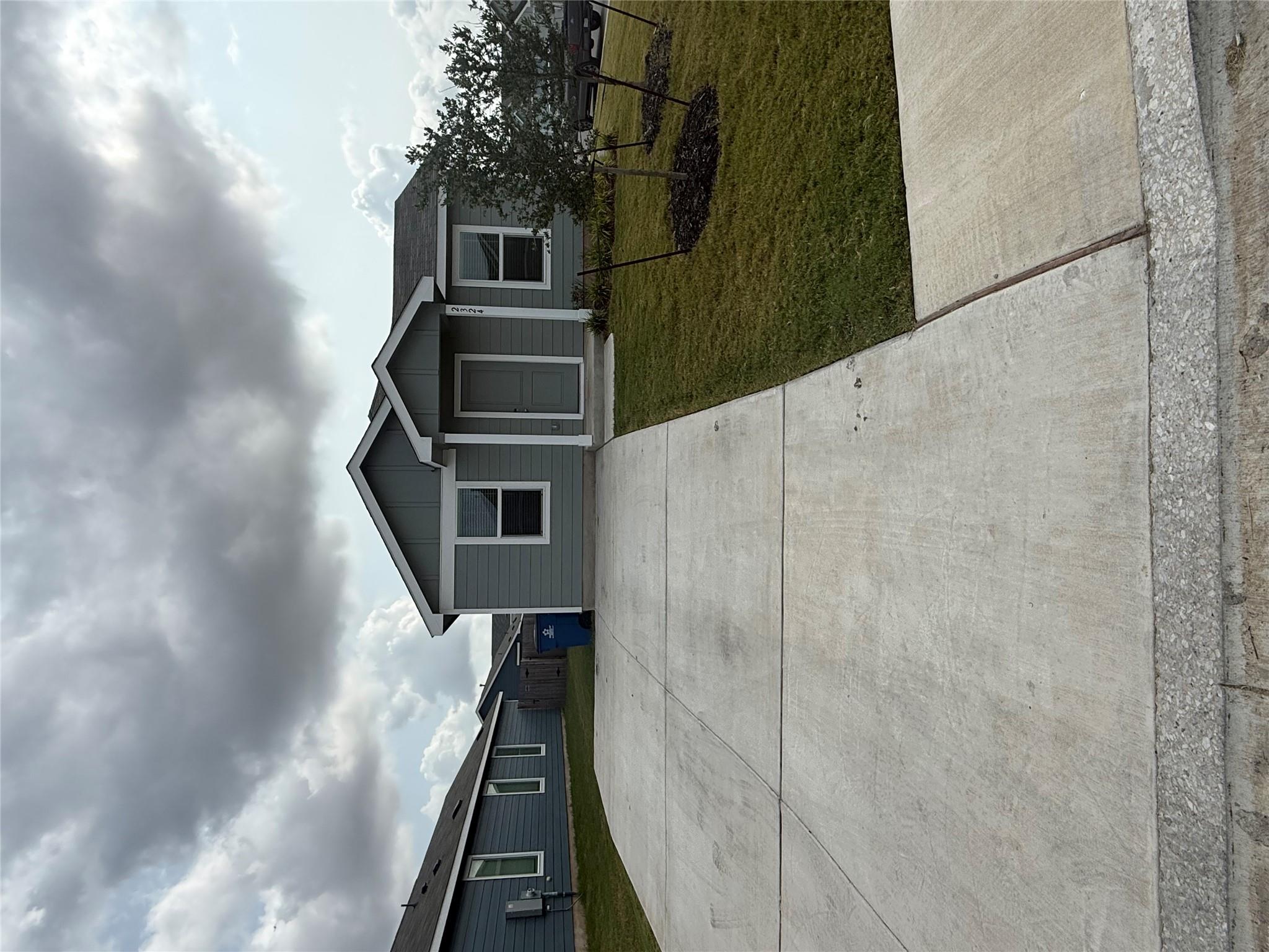 A welcoming front facade with a neat lawn and spa