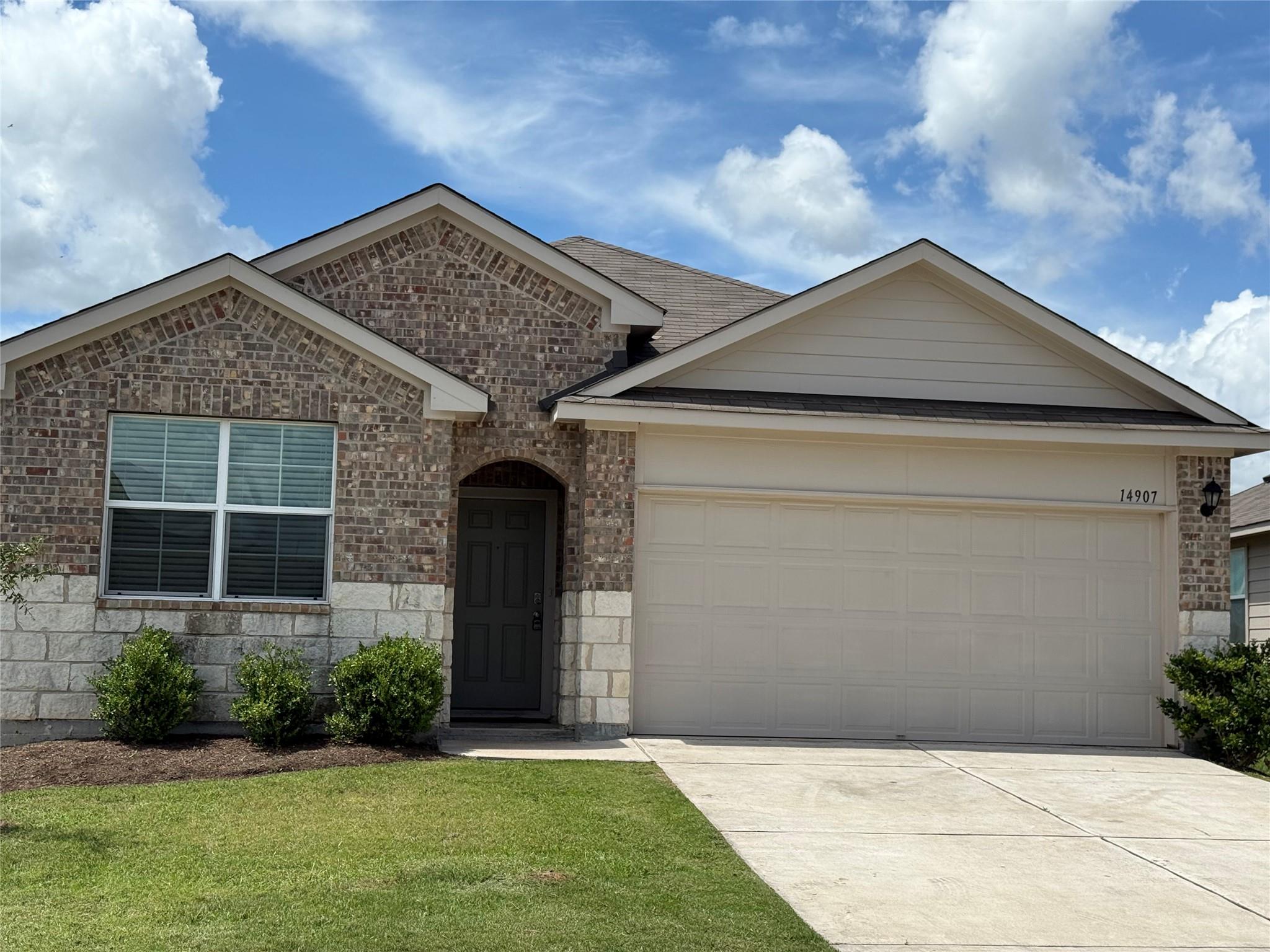 Attractive brick and stone facade welcomes you to
