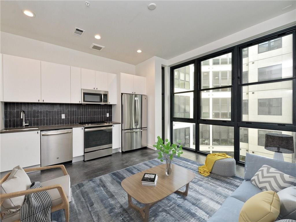 Towering floor-to-ceiling windows illuminate a mo