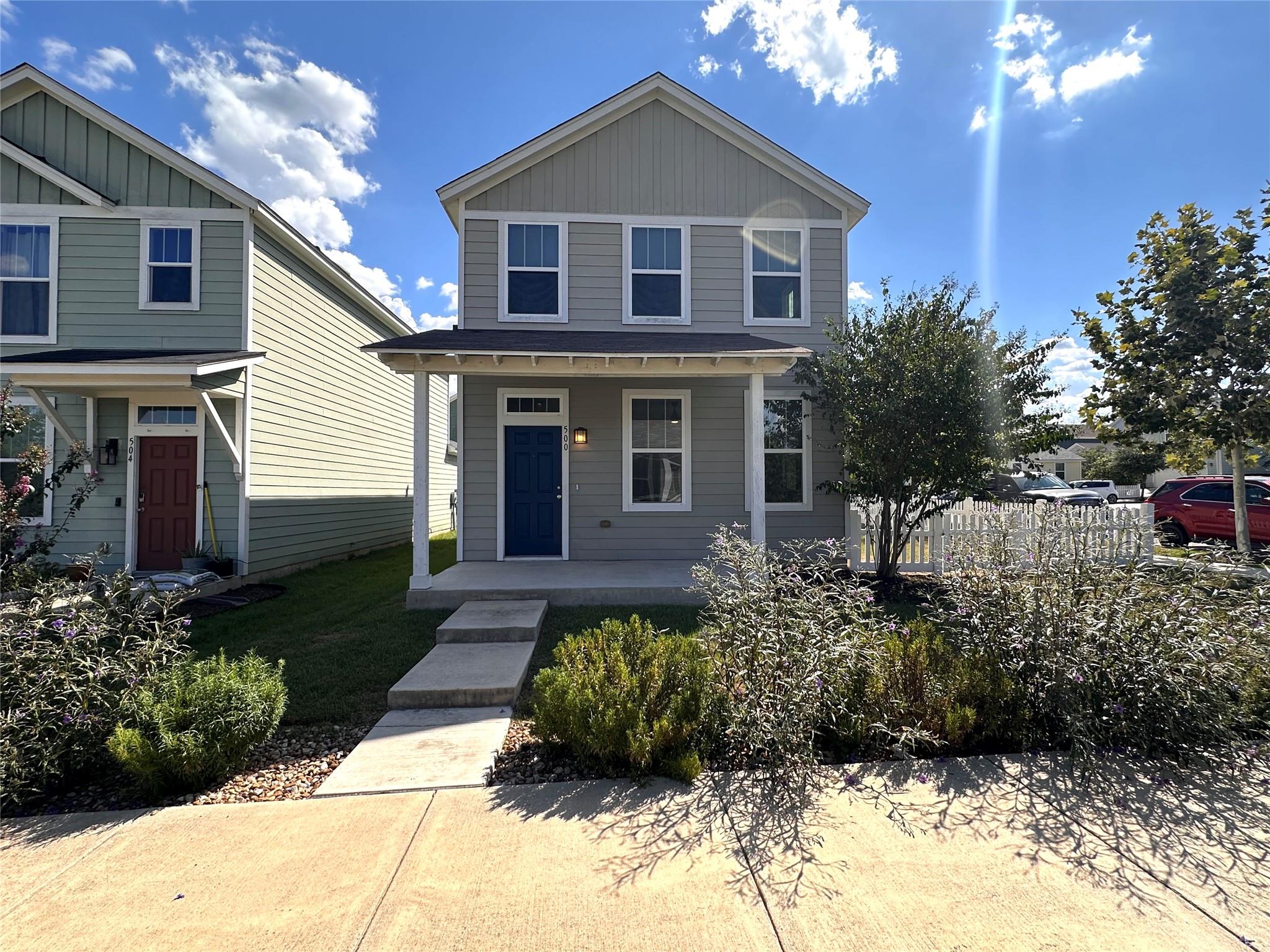 A welcoming front porch and classic siding define