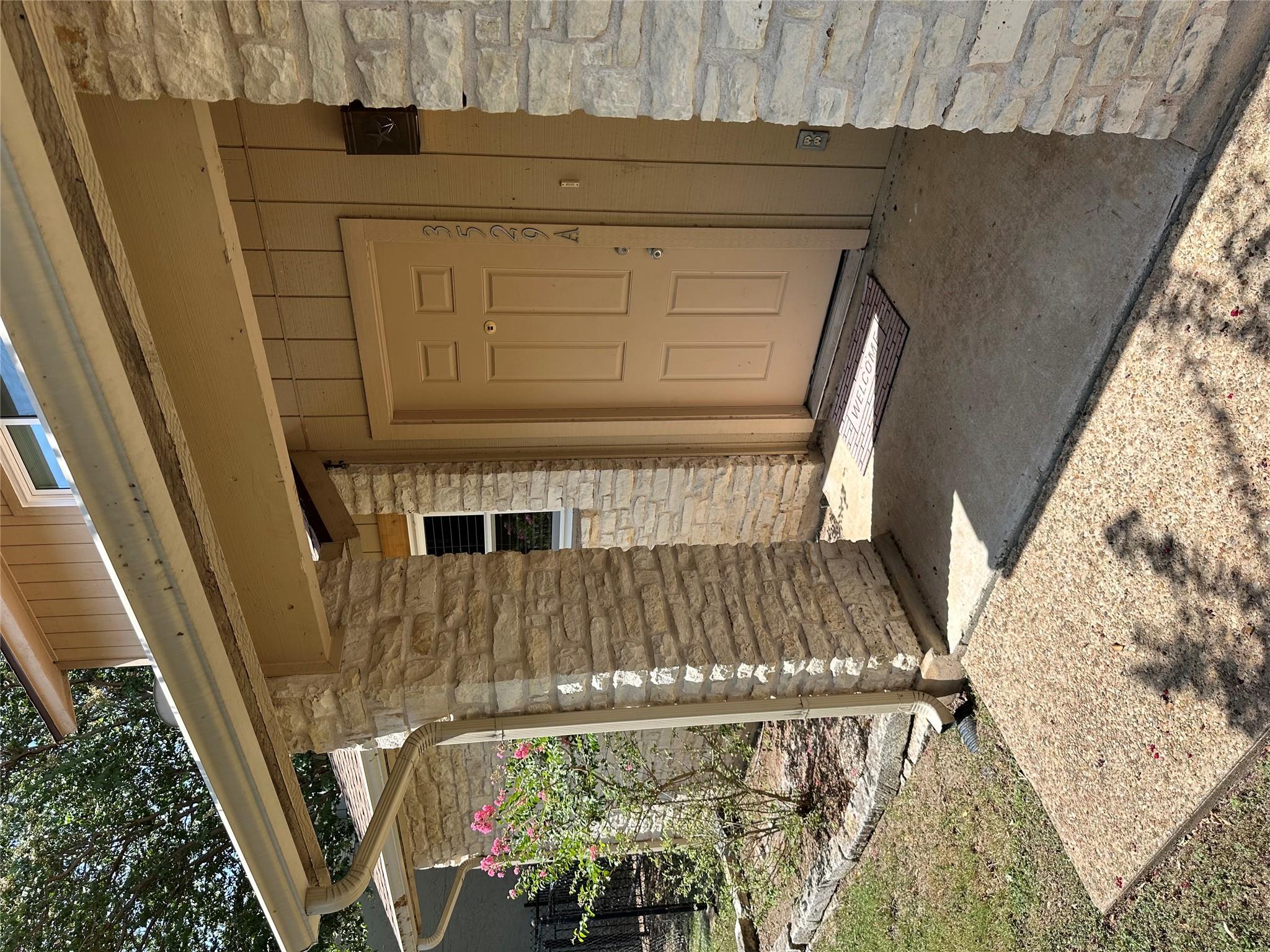 A welcoming entry, with durable stone accents, hi