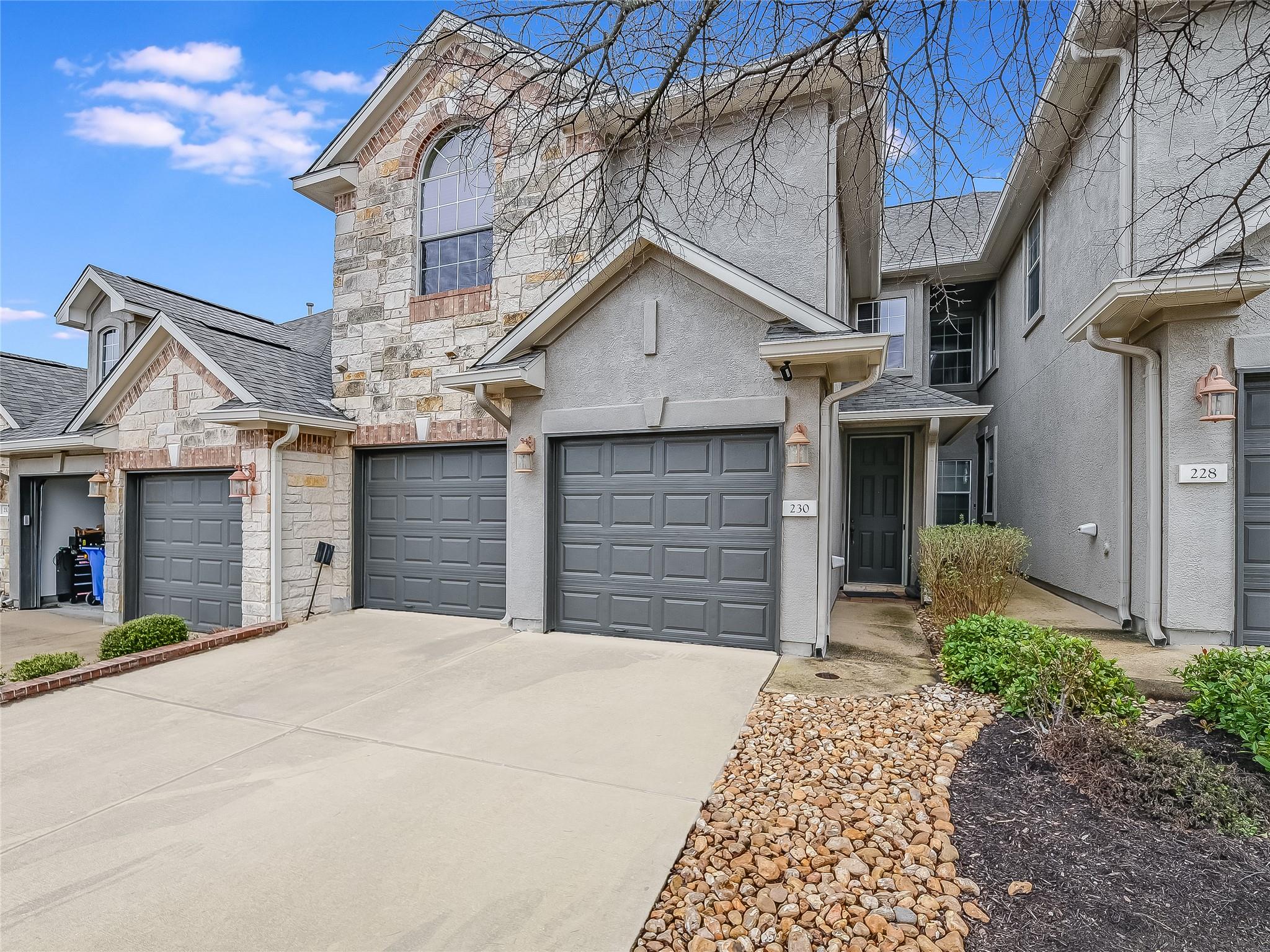 A striking exterior featuring stone and stucco fi