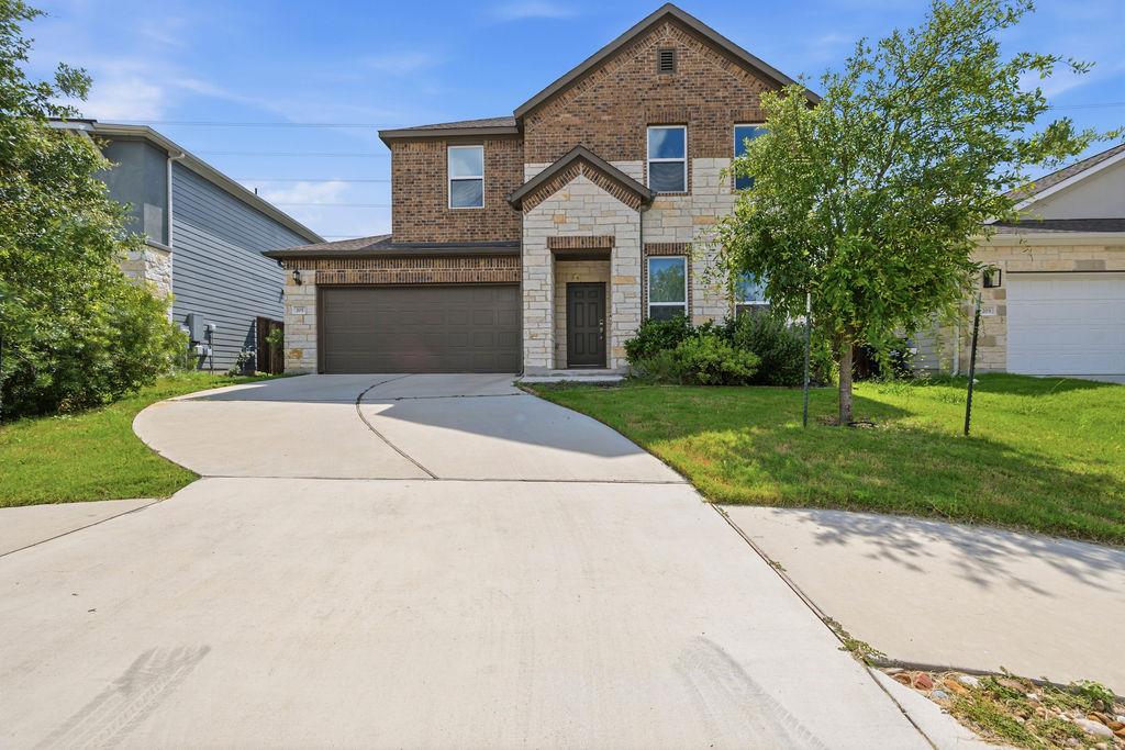Brick and stone facade home with attached garage 