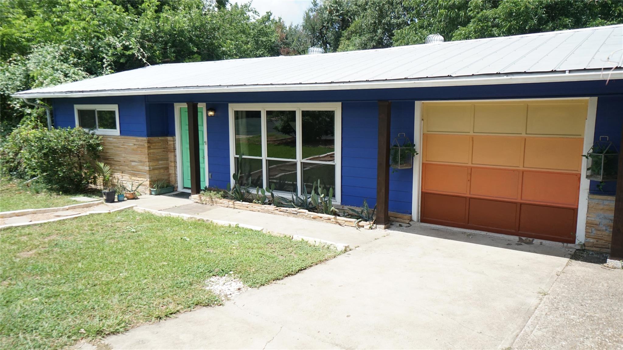 A vibrant blue facade with stone accents and a un