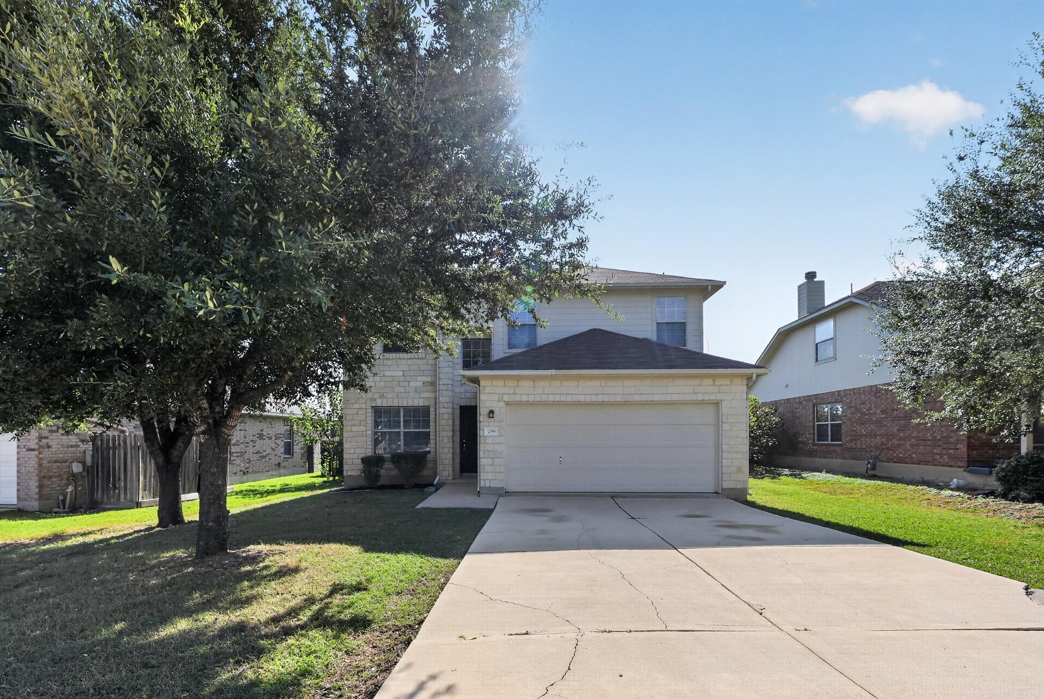 A well-maintained two-story home features a concr