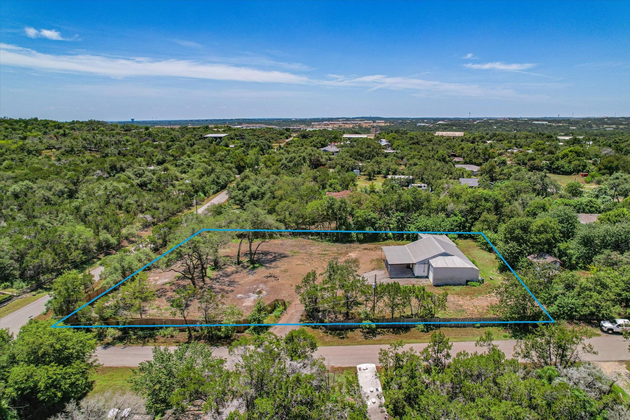 An aerial perspective reveals a private, tree-lin
