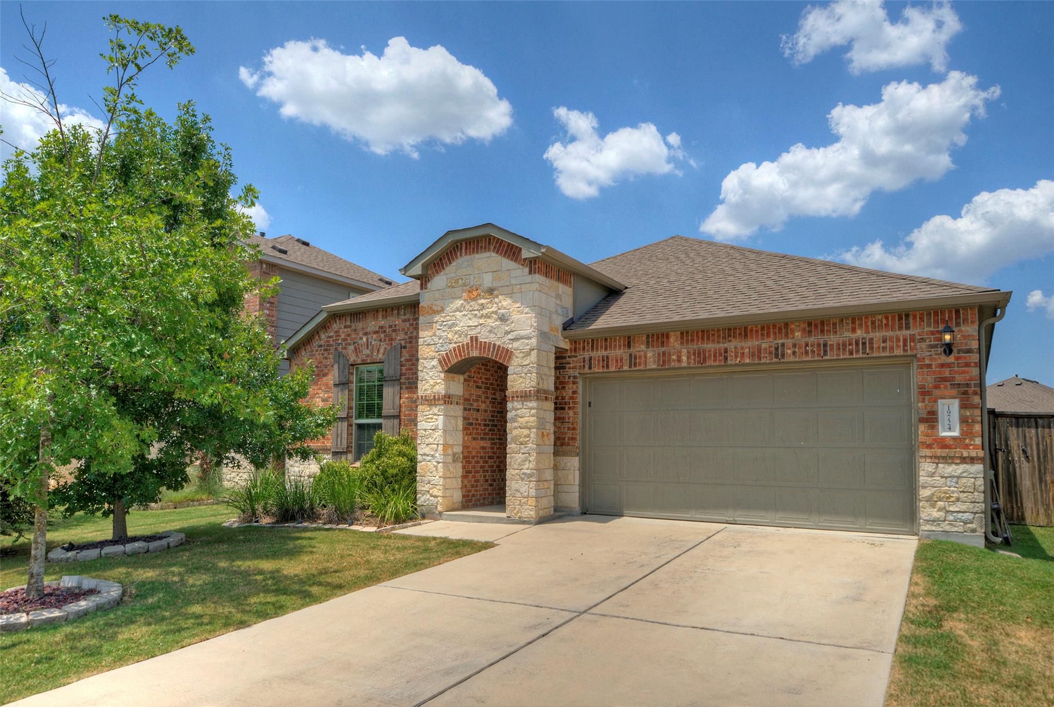 Brick and stone facade with an arched entryway we